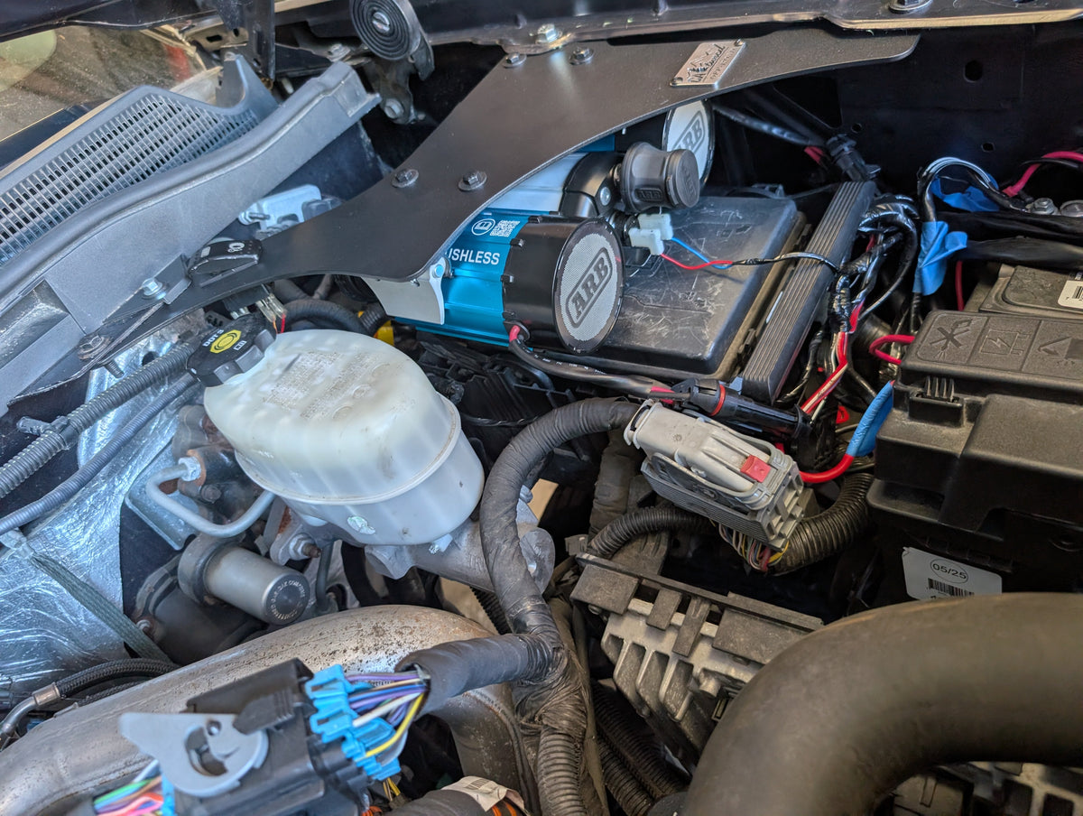 CAtuned Off-Road ARB Twin Air Compressor under hood for Sierra/Silverado 2500.