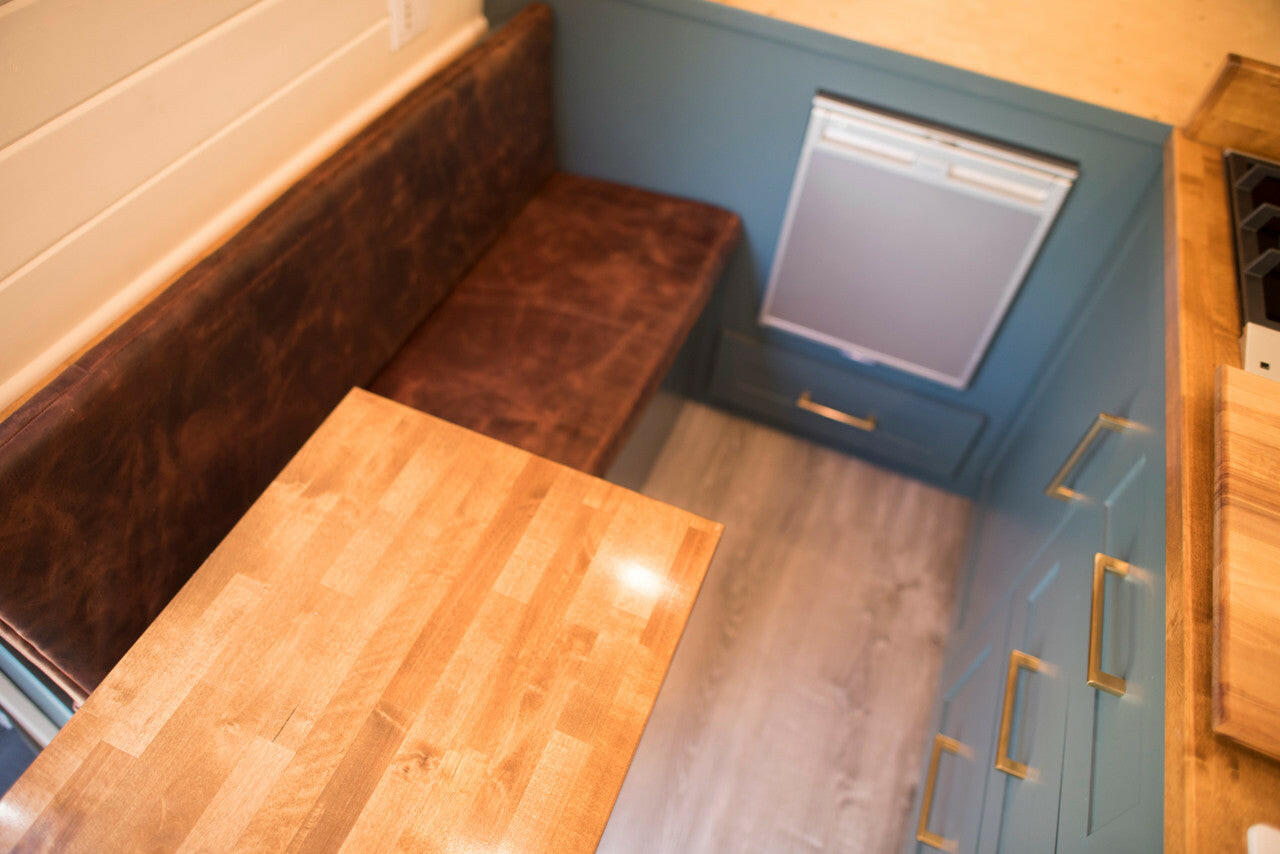 Elements like a solid wood table top, genuine leather cushions and high efficiency appliances are hallmarks of our van conversions.