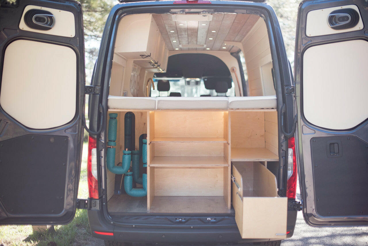 The Adventure offers a plentiful storage space underneath the bed. Complete with custom shelving and pull-out drawers.